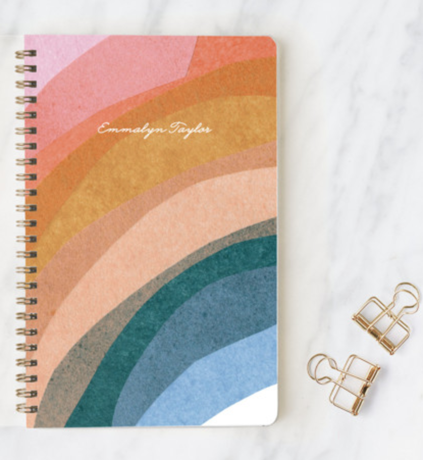 Rainbow Collage weekly planner from Minted on a marble tabletop next to 2 gold paperclips